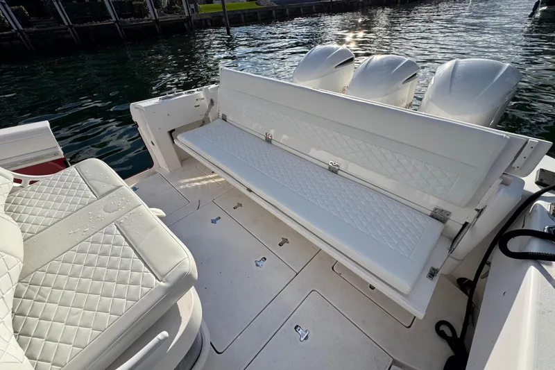 Slide: The Image of 2017 Intrepid 375 Center Console boat with white quilted seating and triple outboard engines. - 20