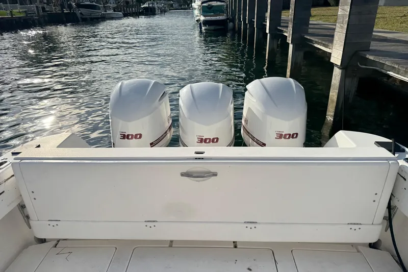 Slide: The Image of 2017 Intrepid 375 Center Console with triple Yamaha 300 engines docked by the water. - 21