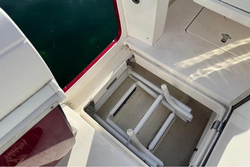 Slide: The Image of 2017 Intrepid 375 Center Console boat storage compartment with ladder, open hatch view. - 22