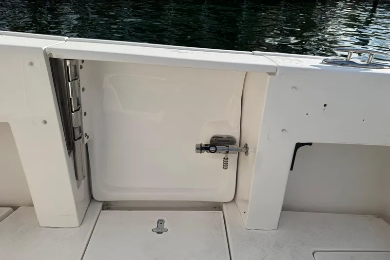 Slide: The Image of 2017 Intrepid 375 Center Console boat deck with a closed hatch and latch. - 24