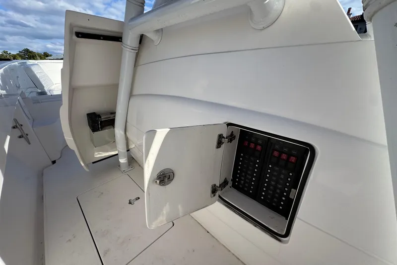 Slide: The Image of 2017 Intrepid 375 Center Console electrical panel with open compartment on deck. - 26