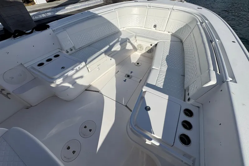 Slide: The Image of 2017 Intrepid 375 Center Console boat interior with white seating and storage compartments. - 7