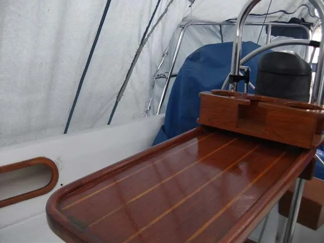 Slide: The Image of Interior view of a 1990 Catalina 27 yacht with wooden table. - 11