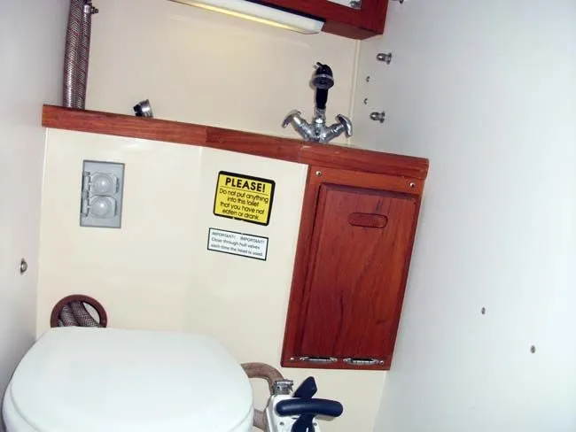 Slide: The Image of Interior of a 1990 Catalina 27 yacht with toilet and sink. - 17