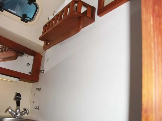 Slide: The Image of Interior of a 1990 Catalina 27 yacht with wooden shelves. - 18