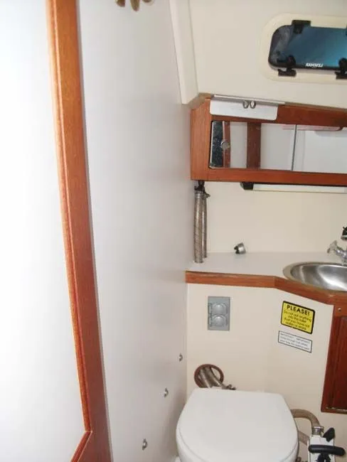 Slide: The Image of Interior of a 1990 Catalina 27 yacht with toilet and sink. - 19