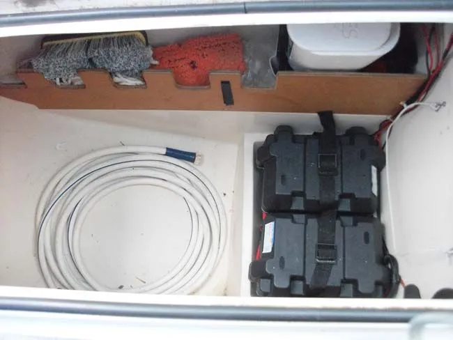 Slide: The Image of Interior of a 1990 Catalina 27 with batteries and cables. - 23