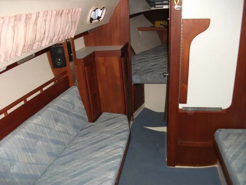 Slide: The Image of Interior of a 1990 Catalina 27 yacht with blue upholstery. - 25