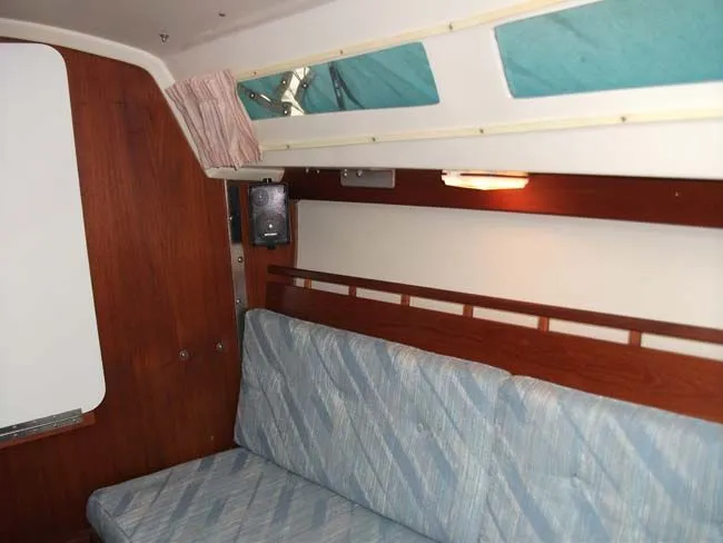 Slide: The Image of Interior of a 1990 Catalina 27 yacht with blue upholstery. - 28