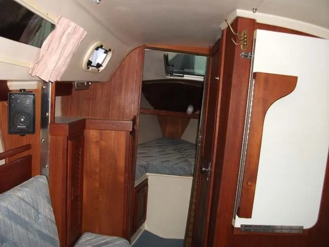 Slide: The Image of Interior of a 1990 Catalina 27 yacht with wooden furnishings. - 29