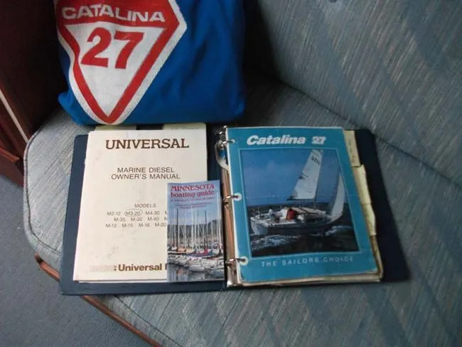 Slide: The Image of Catalina 27 manuals and guide on a seat. - 31