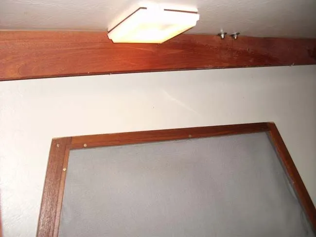 Slide: The Image of Interior of a 1990 Catalina 27 yacht with wood trim and ceiling light. - 4