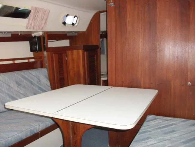Slide: The Image of Interior of a 1990 Catalina 27 with wood furnishings and seating area. - 6
