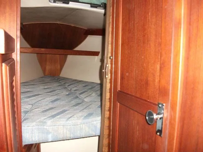 Slide: The Image of Interior of a 1990 Catalina 27 sailboat with wooden furnishings. - 8
