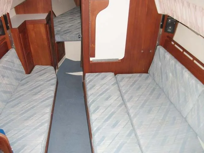 Slide: The Image of Interior of a 1990 Catalina 27 yacht with blue upholstery. - 9