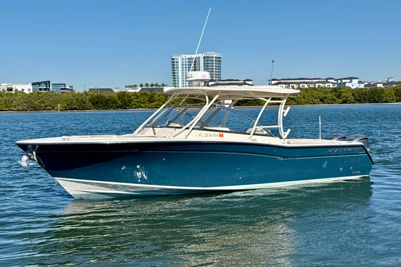 The Image of 2016 Grady-White Freedom 307 boat on calm water, clear sky background. - 0