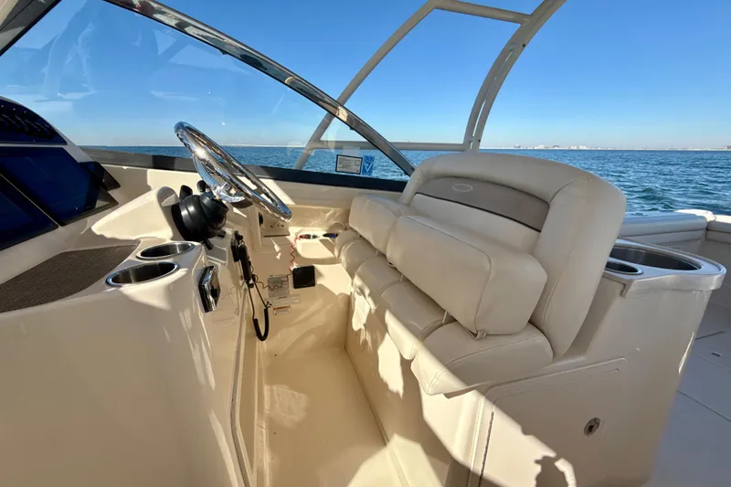 Slide: The Image of 2016 Grady-White Freedom 307 boat dashboard with navigation screens and ocean view. - 12