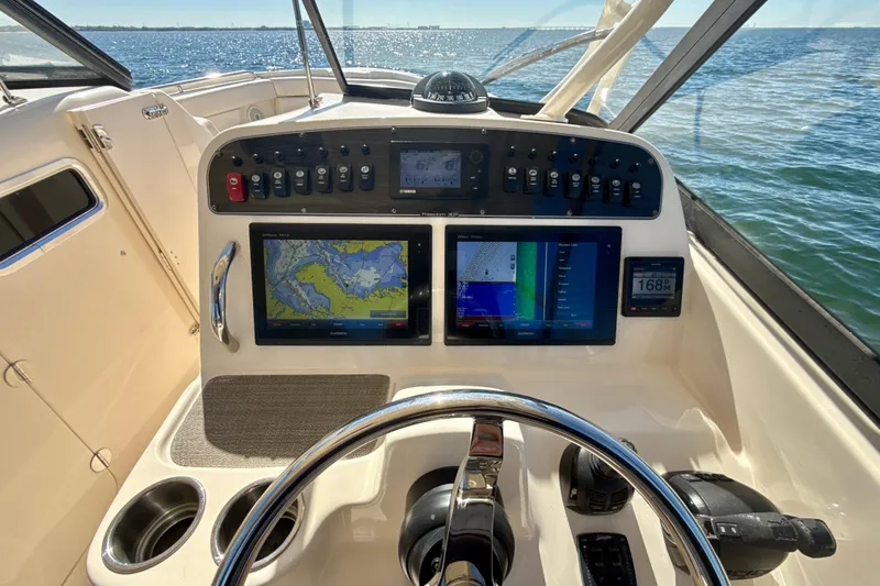 Slide: The Image of 2016 Grady-White Freedom 307 boat interior with beige seating and ocean view. - 14