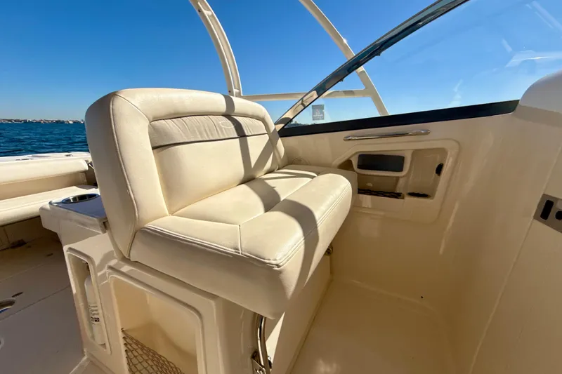 Slide: The Image of 2016 Grady-White Freedom 307 boat interior with seating, overlooking calm blue waters. - 17