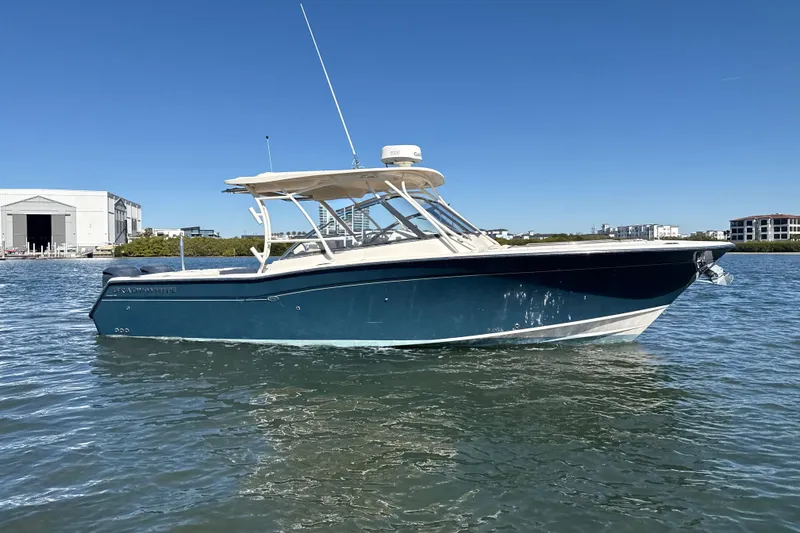 Slide: The Image of 2016 Grady-White Freedom 307 boat on calm water under clear blue sky. - 2