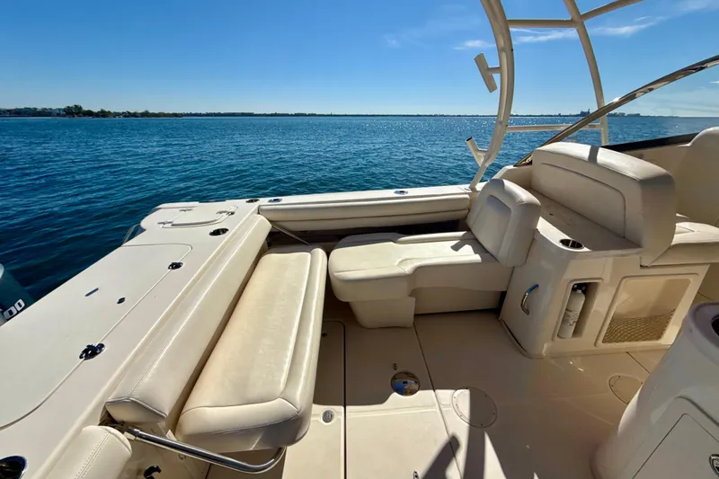 Slide: The Image of 2016 Grady-White Freedom 307 boat interior with sink, storage, and seating. - 20