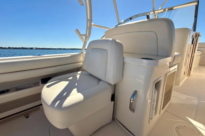 Slide: The Image of 2016 Grady-White Freedom 307 boat interior with ocean view and seating area. - 22