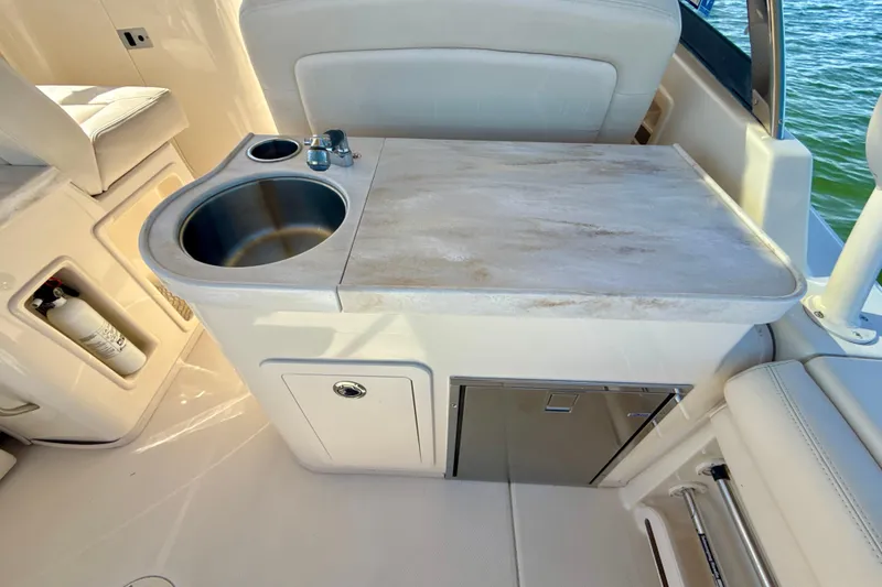 Slide: The Image of 2016 Grady-White Freedom 307 boat interior with white seating, ocean view. - 24