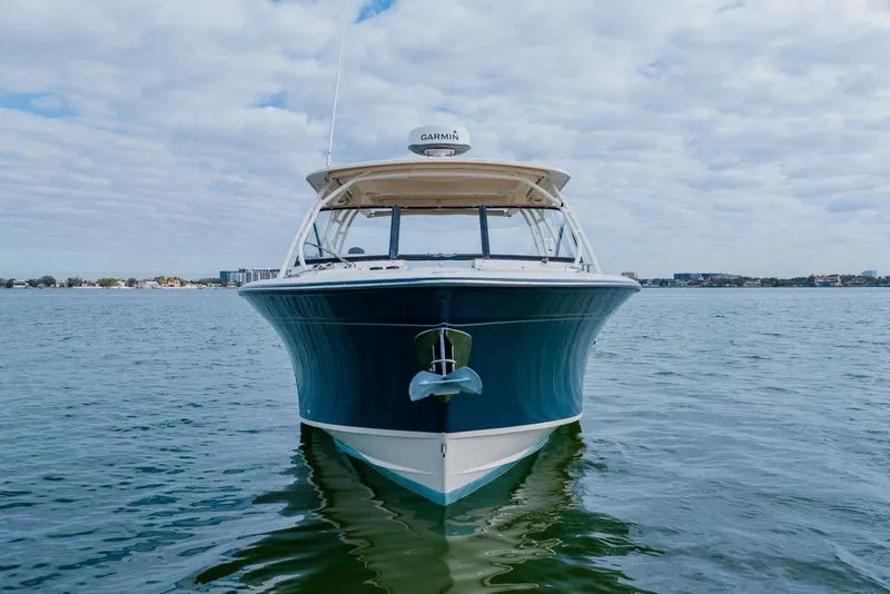 Slide: The Image of 2016 Grady-White Freedom 307 boat on calm water under cloudy sky. - 28