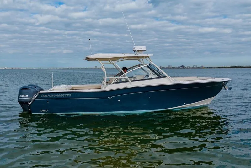 Slide: The Image of 2016 Grady-White Freedom 307 boat on calm water under cloudy sky. - 29