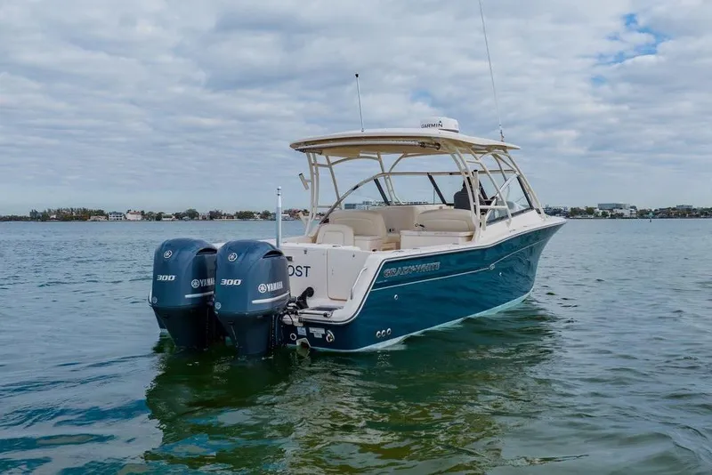 Slide: The Image of 2016 Grady-White Freedom 307 boat with twin Yamaha engines on calm water. - 30