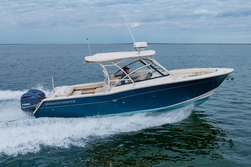 Slide: The Image of 2016 Grady-White Freedom 307 boat cruising on open water. - 33