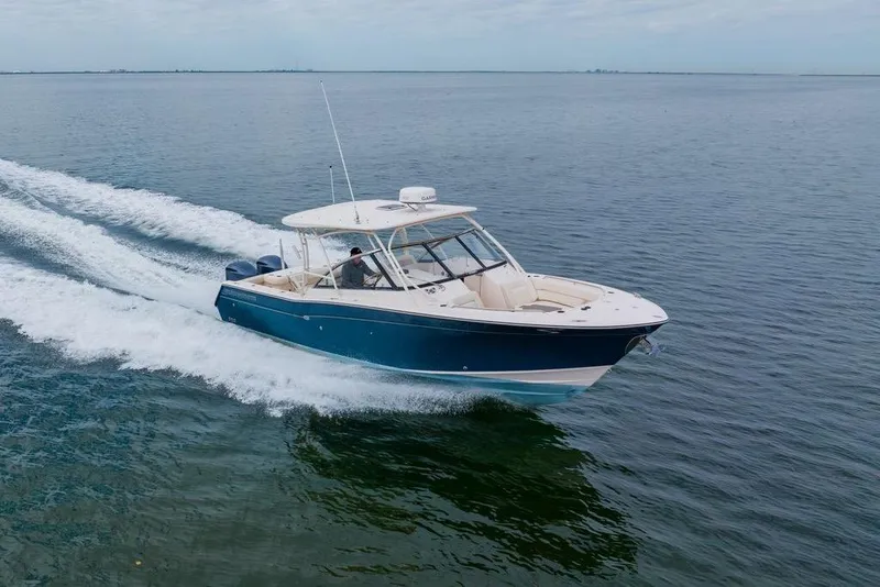 Slide: The Image of 2016 Grady-White Freedom 307 cruising on open water, showcasing sleek design and performance. - 34