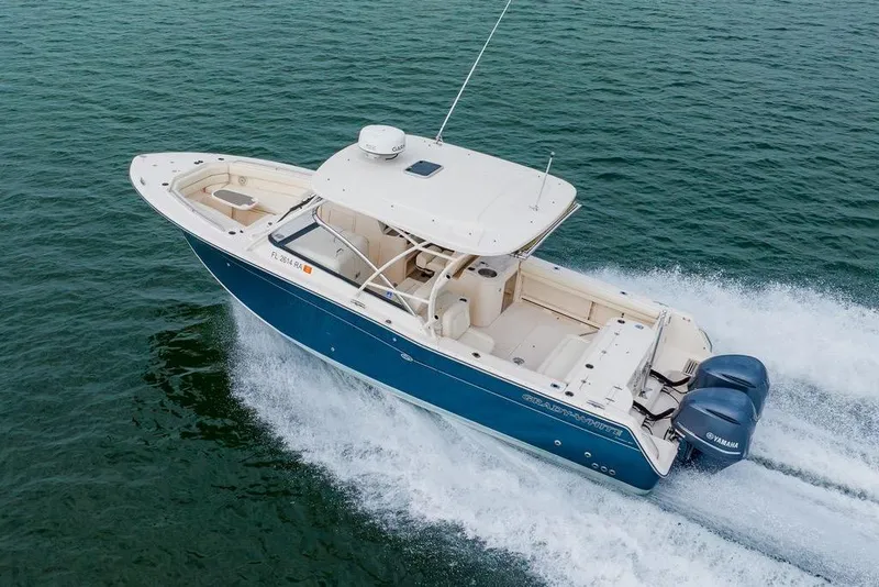 Slide: The Image of 2016 Grady-White Freedom 307 boat cruising on open water. - 38
