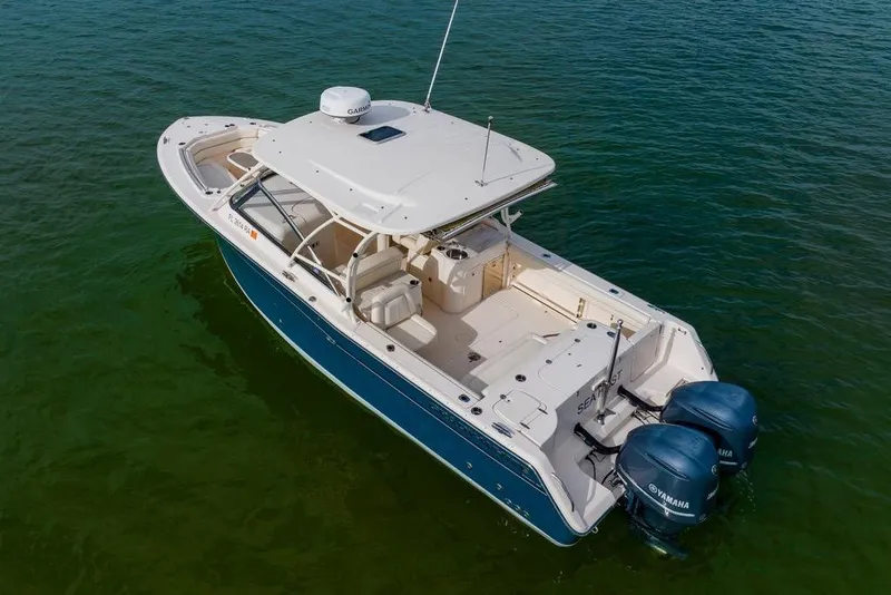 Slide: The Image of 2016 Grady-White Freedom 307 boat with dual Yamaha engines on calm water. - 41