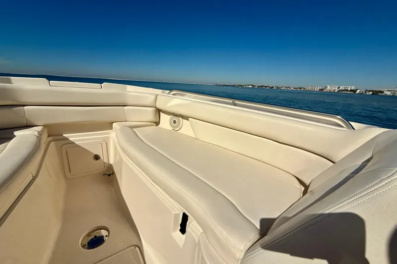 Slide: The Image of 2016 Grady-White Freedom 307 boat interior with seating and helm, on open water. - 5