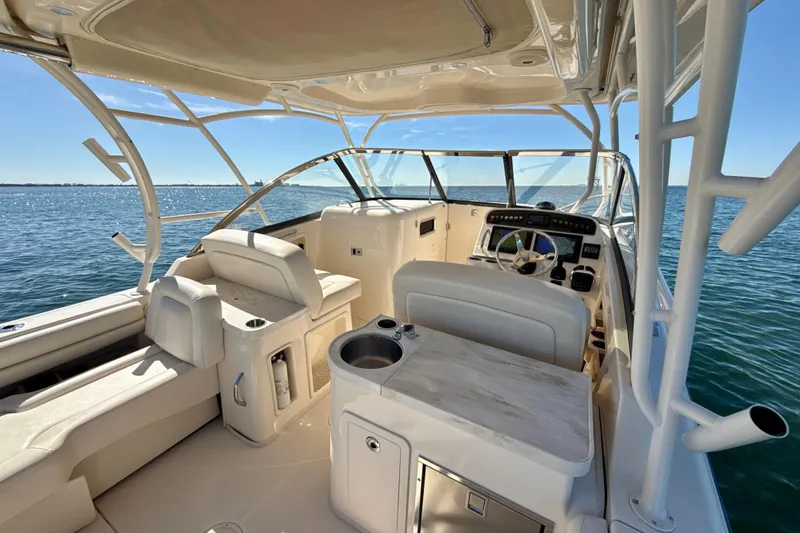 Slide: The Image of 2016 Grady-White Freedom 307 boat interior with helm and seating, ocean view. - 7