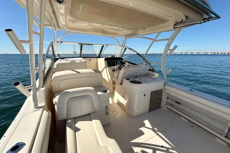 Slide: The Image of 2016 Grady-White Freedom 307 boat cockpit with steering wheel and navigation screens on open water. - 8