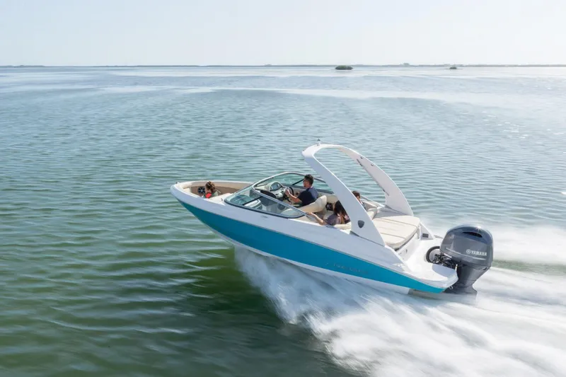 Slide: The Image of 2026 Regal 21 OBX boat cruising on open water, featuring a sleek design and Yamaha outboard motor. - 3
