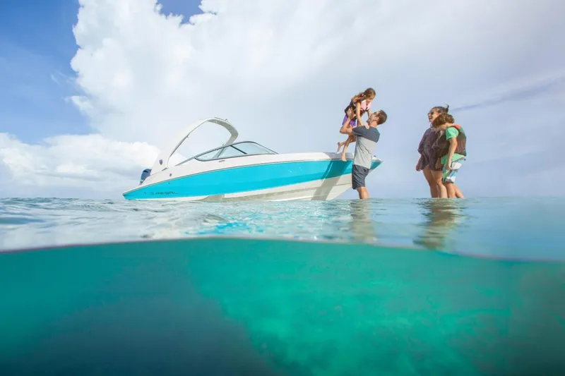 Slide: The Image of Family enjoying a day on the water with a 2026 Regal 21 OBX boat. - 5