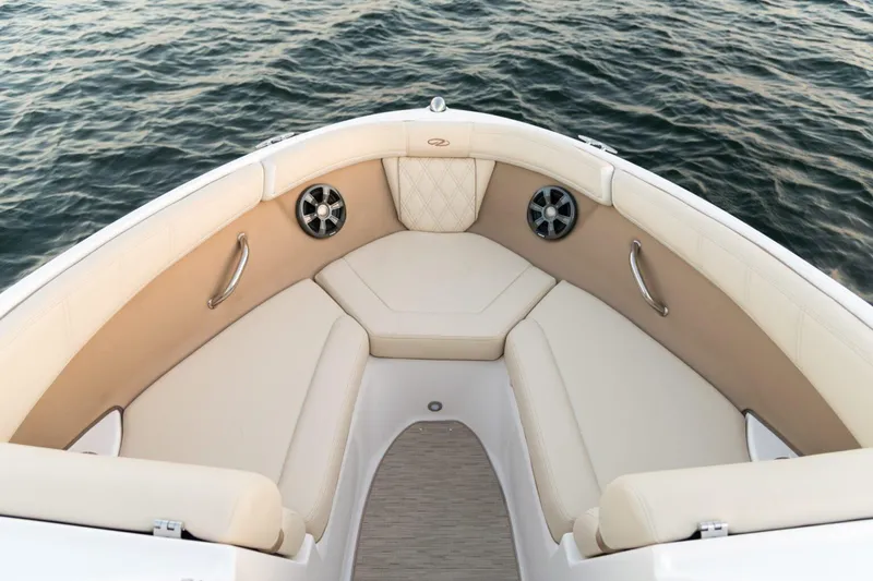 Slide: The Image of Luxurious seating on 2026 Regal 21 OBX boat, overlooking calm water. - 6