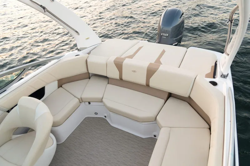Slide: The Image of 2026 Regal 21 OBX boat interior with beige seating, on calm water. - 7