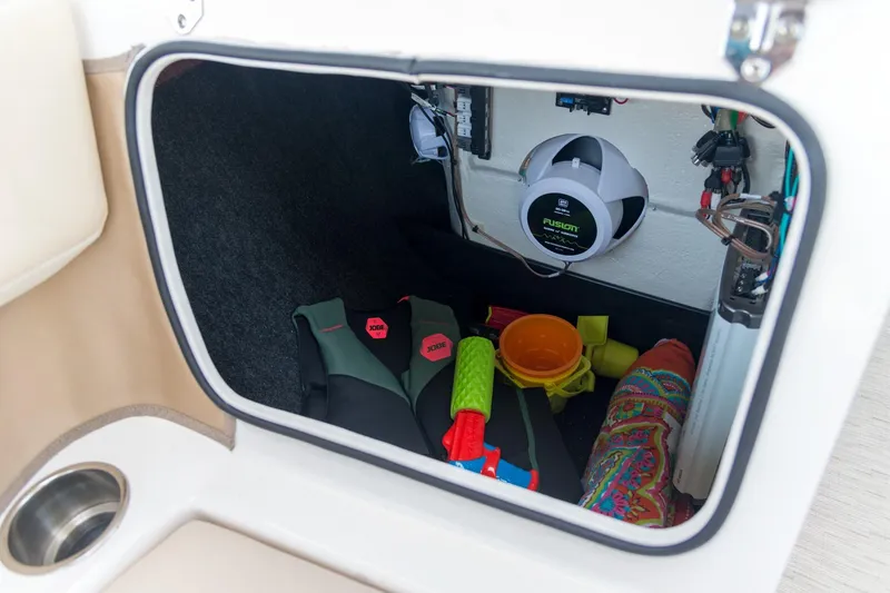 Slide: The Image of Storage compartment of 2026 Regal 21 OBX boat with life vests and toys. - 9