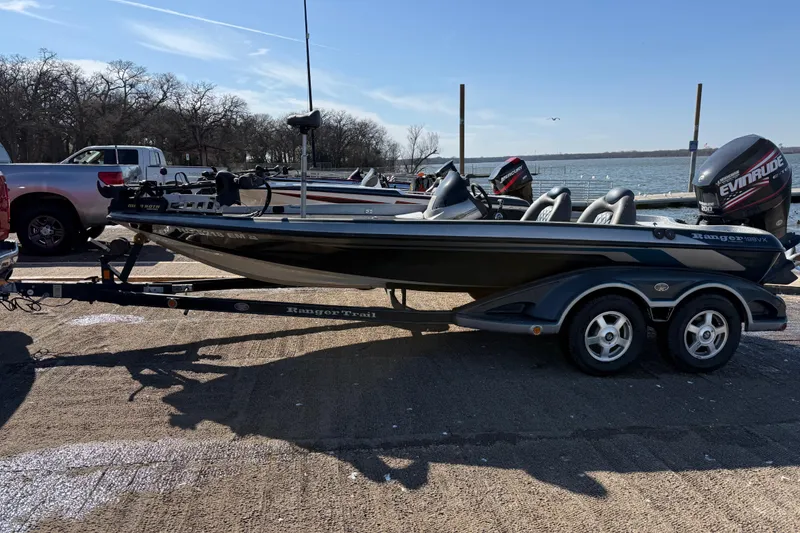Slide: The Image of 2008 Ranger 198 VX boat on trailer, Evinrude motor, parked outdoors. - 10
