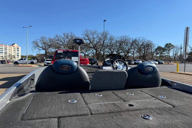 Slide: The Image of 2008 Ranger 198 VX boat interior with steering wheel, parked outdoors under clear blue sky. - 18