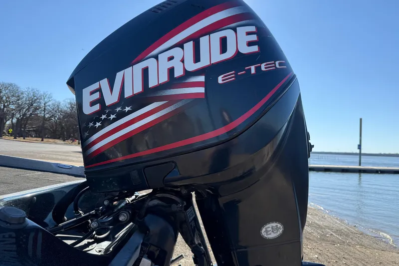 Slide: The Image of Evinrude E-TEC outboard motor on 2008 Ranger 198 VX boat by a lake. - 19
