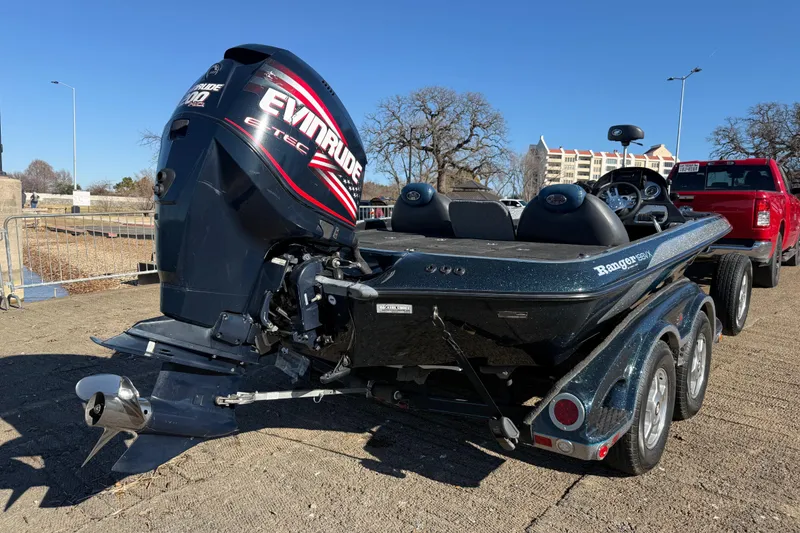 Slide: The Image of 2008 Ranger 198 VX boat with Evinrude motor on trailer, parked outdoors. - 21