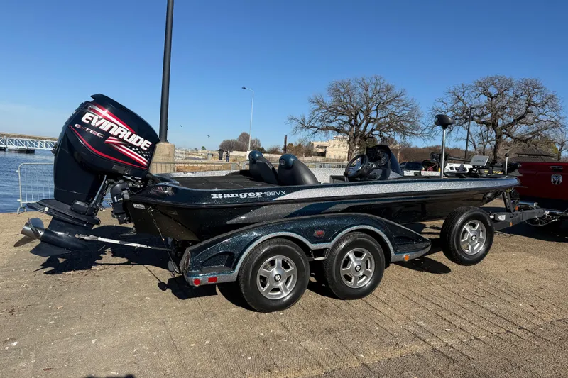 Slide: The Image of 2008 Ranger 198 VX boat with Evinrude engine on a trailer by the water. - 23
