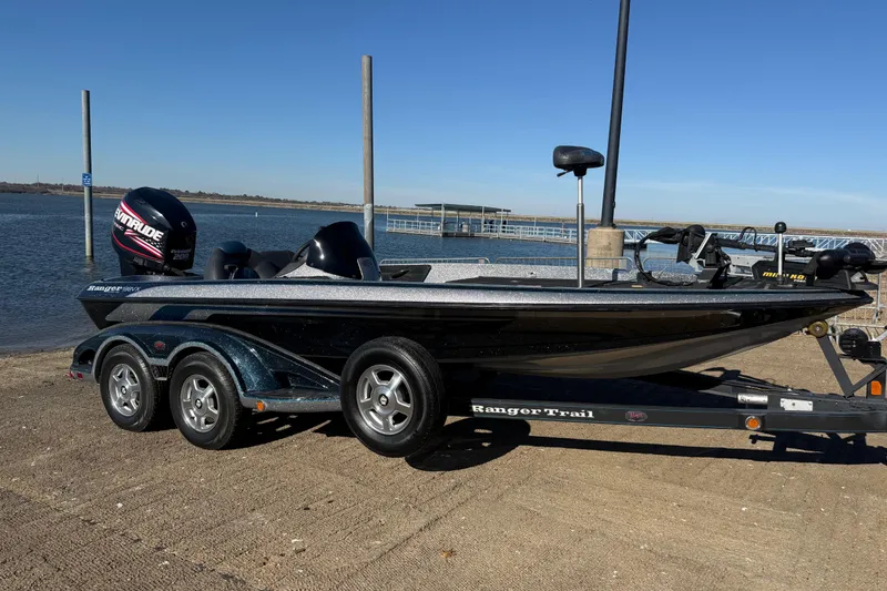 Slide: The Image of 2008 Ranger 198 VX boat on trailer by the water, clear sky background. - 26