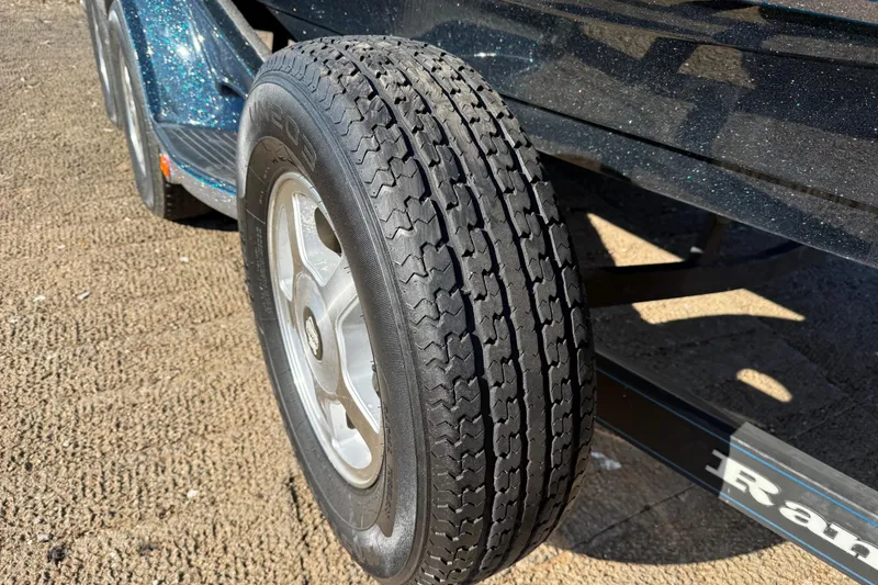 Slide: The Image of 2008 Ranger 198 VX trailer tire on sandy ground, close-up view. - 33