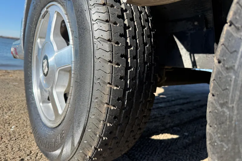 Slide: The Image of Close-up of a 2008 Ranger 198 VX trailer tire on a sandy surface. - 35